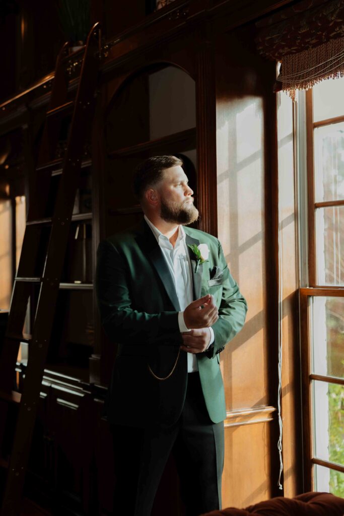 groom getting ready in manor houst at Sandlewood Manor houston wedding photographer