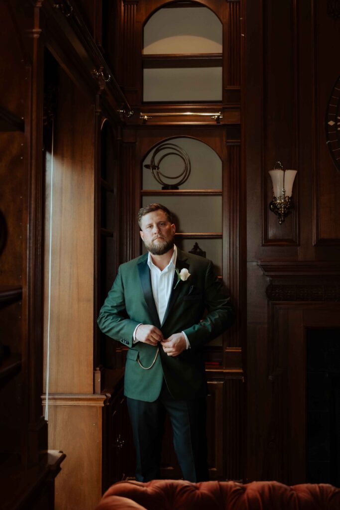groom getting ready in manor houst at Sandlewood Manor houston wedding photographer