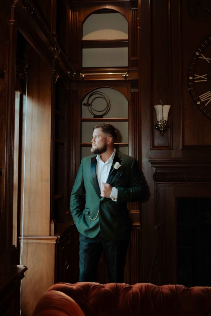 groom getting ready in manor houst at Sandlewood Manor houston wedding photographer