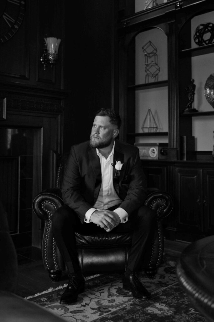 groom getting ready in manor houst at Sandlewood Manor houston wedding photographer